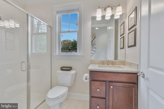 full bathroom with baseboards, vanity, toilet, and a stall shower