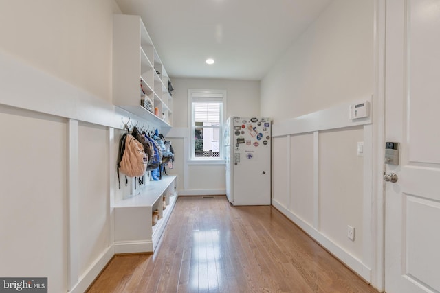 mudroom with baseboards, light wood-style floors, and recessed lighting