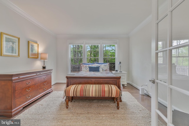 office area featuring light wood-style flooring, baseboards, and crown molding