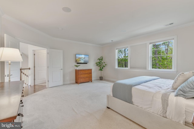 bedroom featuring light colored carpet, baseboards, crown molding, and visible vents