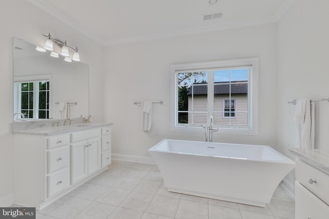 bathroom featuring visible vents, vanity, ornamental molding, and a healthy amount of sunlight