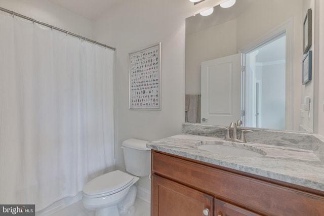bathroom featuring a shower with shower curtain, toilet, vanity, and tile patterned floors