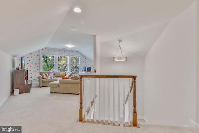 interior space featuring lofted ceiling and baseboards