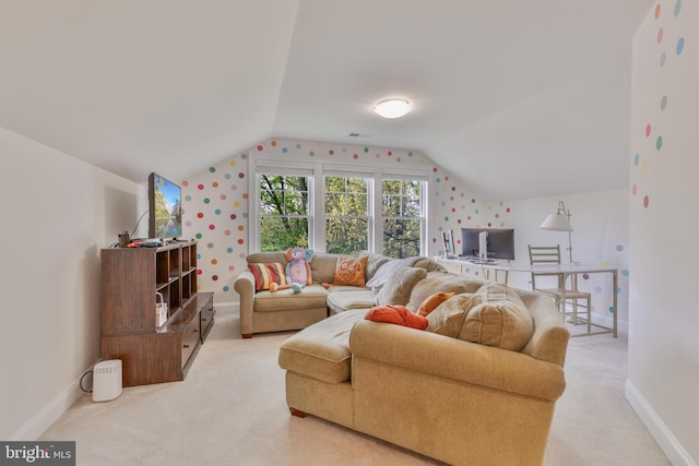 living room featuring baseboards, lofted ceiling, and light colored carpet