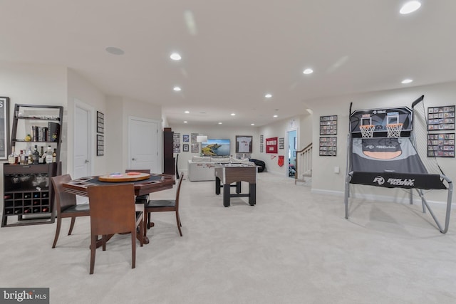 dining area with light carpet, baseboards, recessed lighting, and stairs