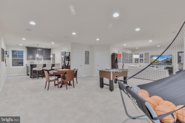 recreation room featuring recessed lighting, baseboards, and light carpet