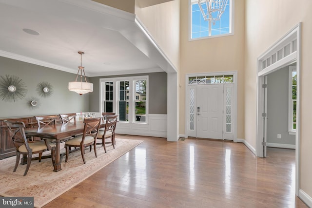 foyer entrance featuring wood finished floors and ornamental molding