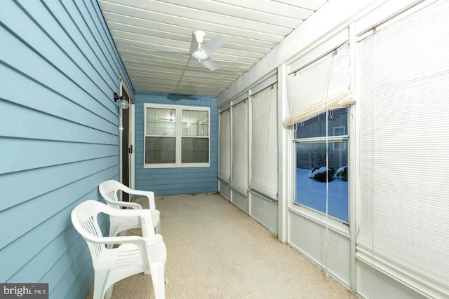 unfurnished sunroom with ceiling fan