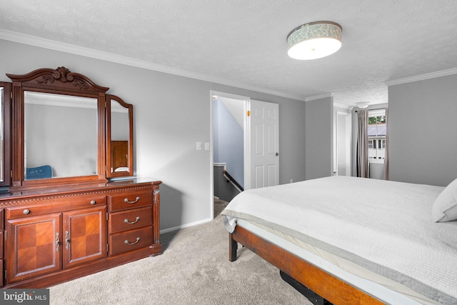 carpeted bedroom with a textured ceiling, ornamental molding, and baseboards