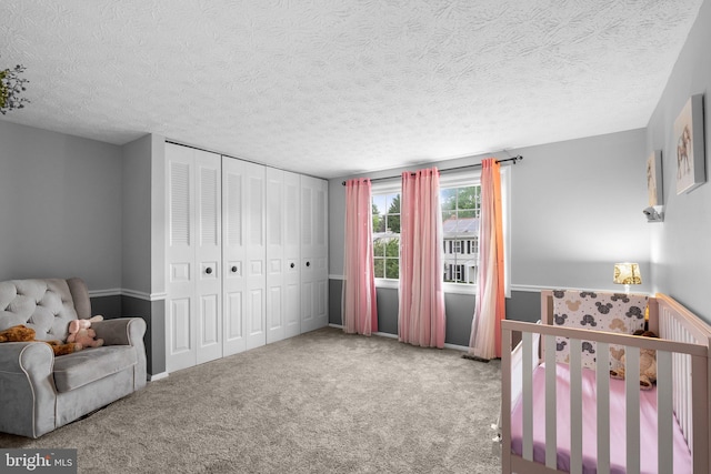 bedroom featuring carpet flooring, a closet, and a textured ceiling