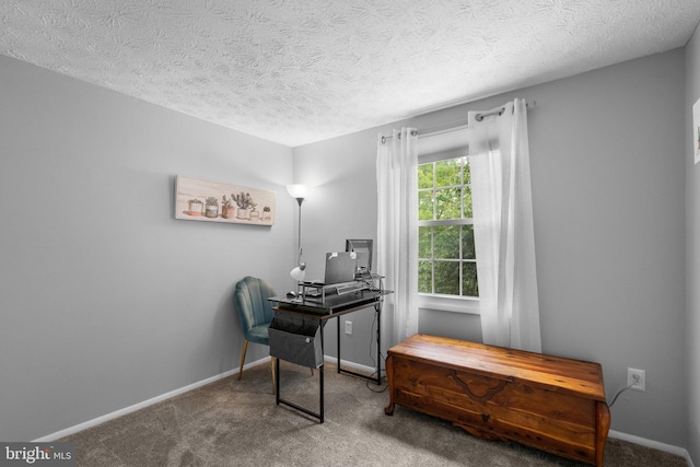 carpeted home office featuring baseboards and a textured ceiling