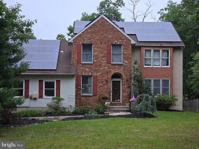 1032 Atsion Rd, Atco, NJ 08004 - traditional-style home featuring roof mounted solar panels, a front lawn, a shingled roof, and brick siding