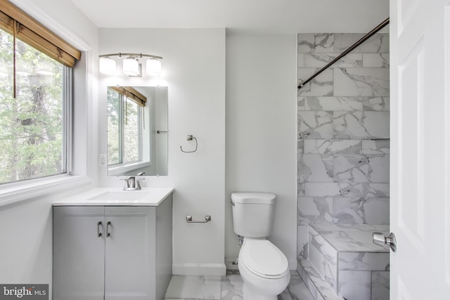 bathroom featuring vanity, toilet, a marble finish shower, marble finish floor, and baseboards