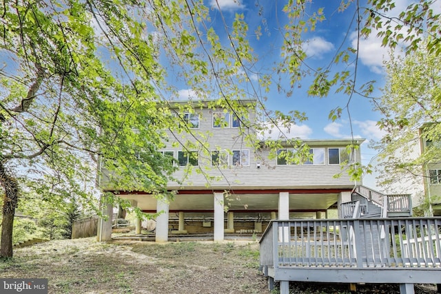 back of house featuring a deck