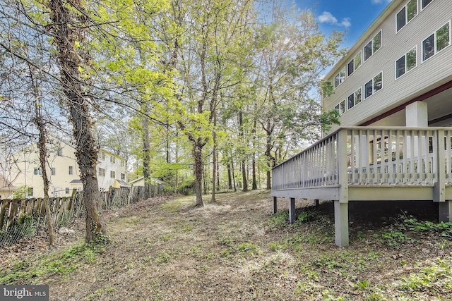 view of yard featuring fence and a deck
