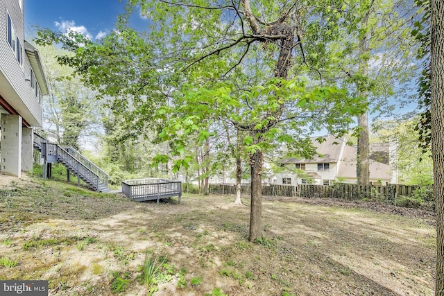 view of yard featuring stairs and fence