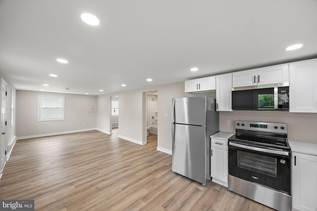 kitchen featuring recessed lighting, light countertops, white cabinetry, and stainless steel appliances