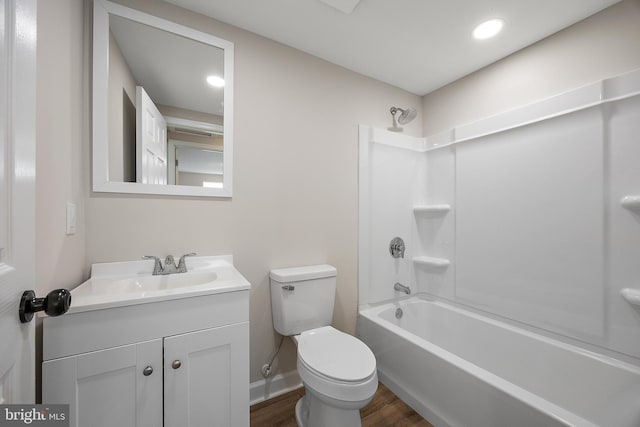 full bathroom with wood finished floors, vanity, baseboards, toilet, and bathing tub / shower combination