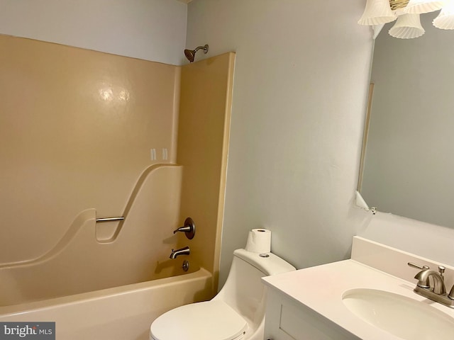 bathroom with toilet, vanity, and shower / tub combination