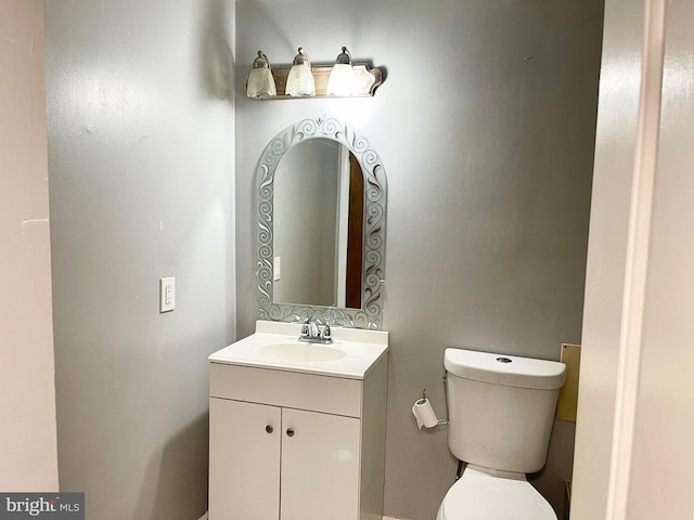 half bath with vanity and toilet