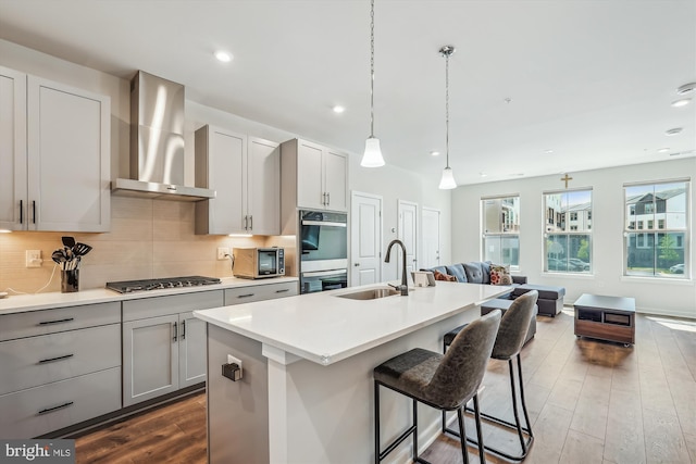 45918 Swallow Ter, Sterling, VA 20165 - kitchen featuring wall chimney exhaust hood, gas cooktop, stainless steel double oven, open floor plan, and backsplash