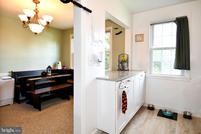 1303 Belle View Blvd Unit B1, Alexandria, VA 22307 - kitchen with white cabinets, plenty of natural light, light stone countertops, and a chandelier