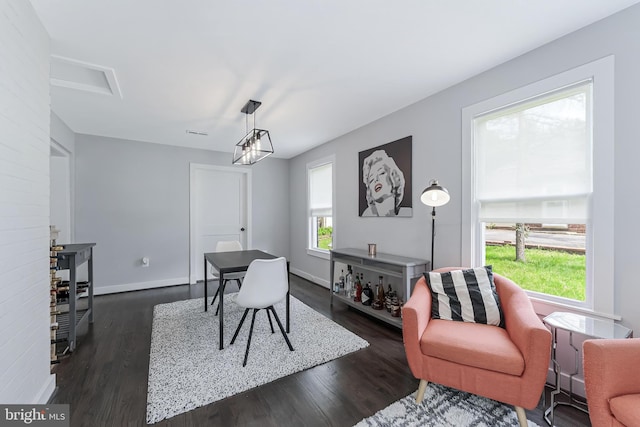 dining space featuring dark wood-style flooring and baseboards