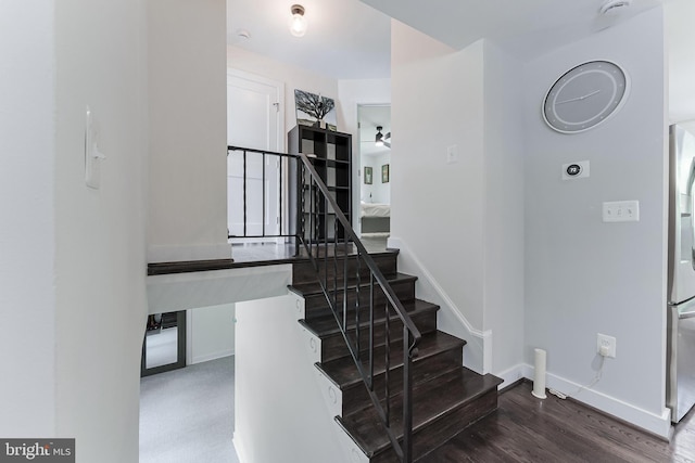 stairs with baseboards and wood finished floors