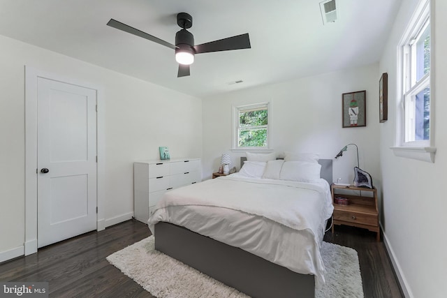 bedroom featuring dark wood-style flooring, baseboards, and a ceiling fan