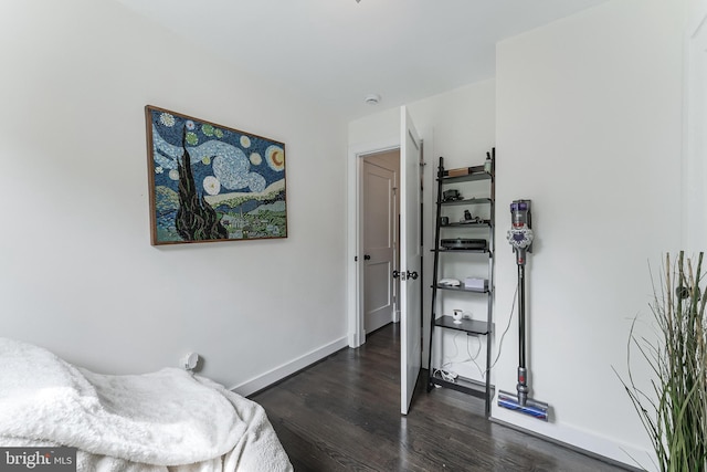 bedroom featuring dark wood-style floors and baseboards