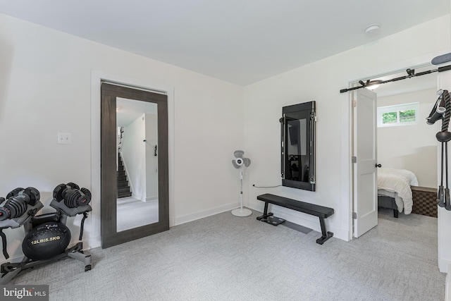 workout room featuring carpet flooring and baseboards