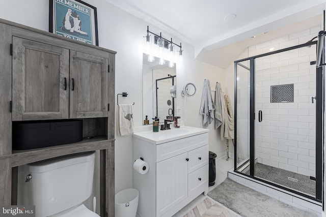 bathroom with toilet, a shower stall, and vanity