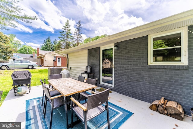 view of patio / terrace with cooling unit, outdoor dining area, and a grill