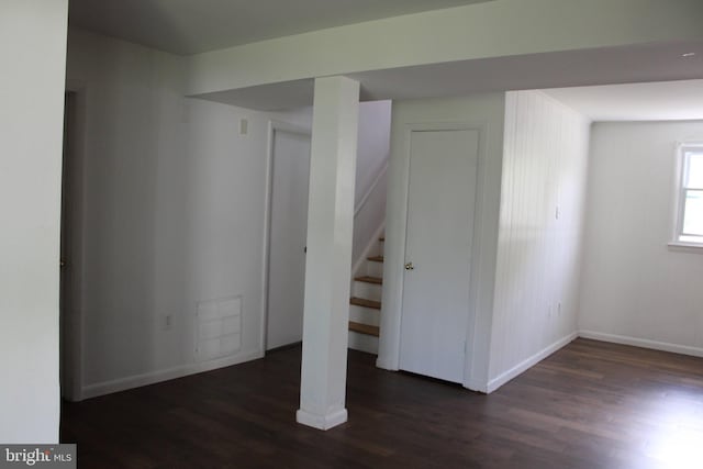 basement featuring visible vents, baseboards, wood finished floors, and stairway