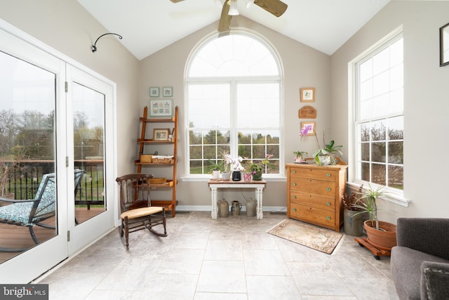 sitting room with baseboards, lofted ceiling, a ceiling fan, and a healthy amount of sunlight