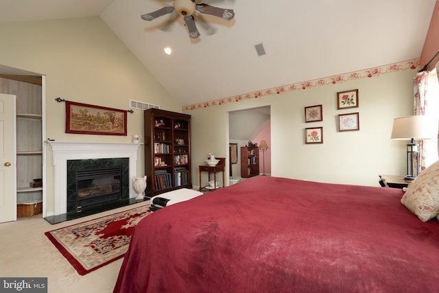 carpeted bedroom featuring a ceiling fan, visible vents, a fireplace, and high vaulted ceiling