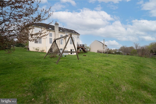 view of yard with stairway and a deck