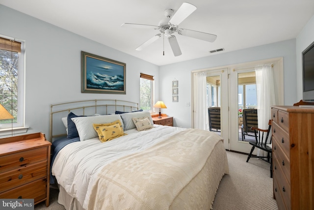 bedroom featuring light carpet, visible vents, access to outside, and ceiling fan