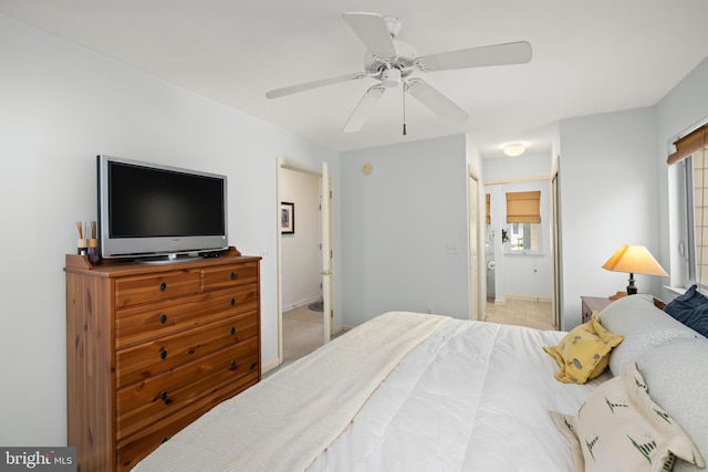 bedroom with a ceiling fan and multiple windows