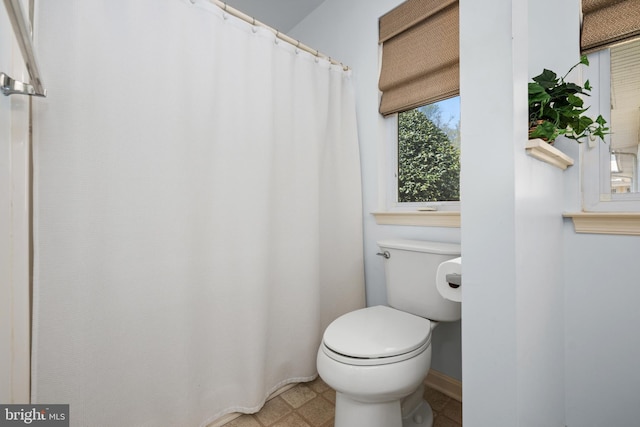 full bath featuring toilet and tile patterned floors