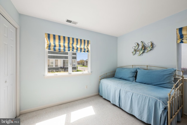 bedroom featuring carpet floors, visible vents, and baseboards
