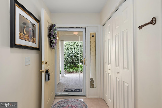 doorway to outside featuring light tile patterned flooring
