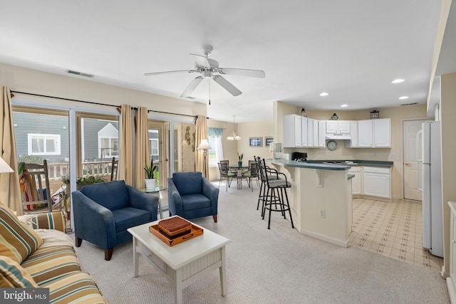 living room featuring recessed lighting, visible vents, a ceiling fan, baseboards, and light colored carpet
