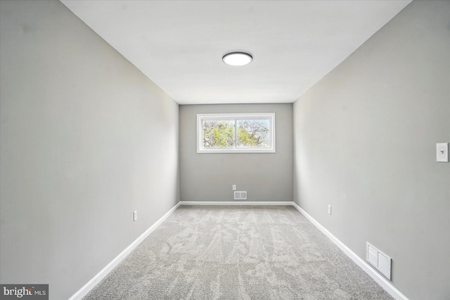 unfurnished room featuring baseboards, carpet flooring, and visible vents
