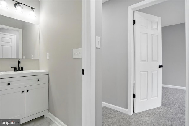 bathroom with baseboards and vanity