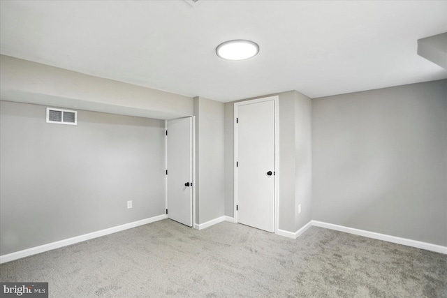 finished basement with carpet floors, visible vents, and baseboards