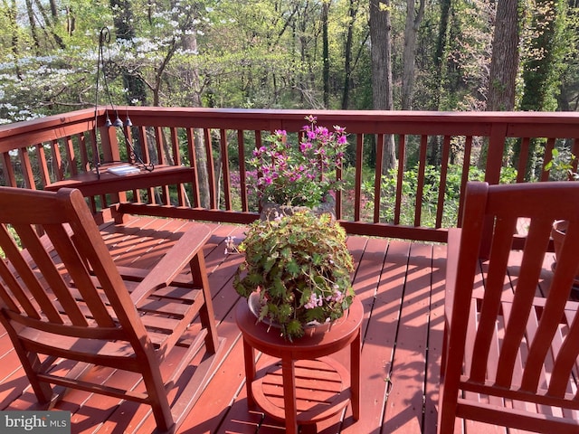wooden deck with a view of trees