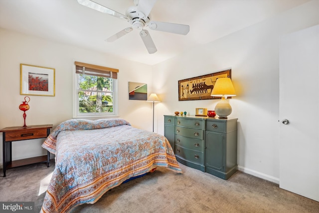 carpeted bedroom with baseboards and a ceiling fan