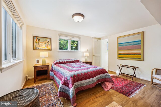 bedroom with wood finished floors and baseboards