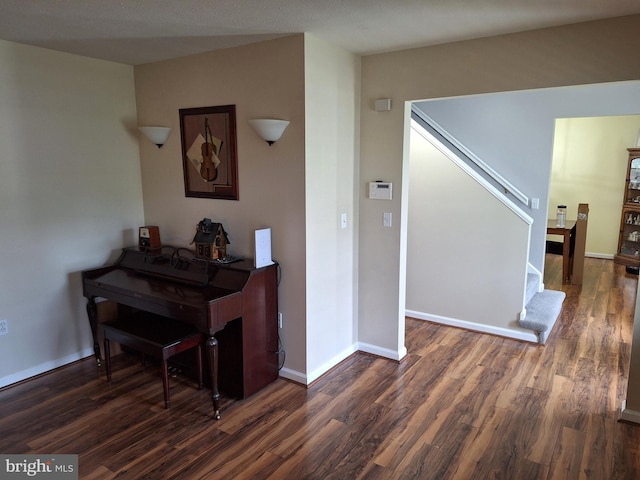 hall with baseboards, stairs, and wood finished floors